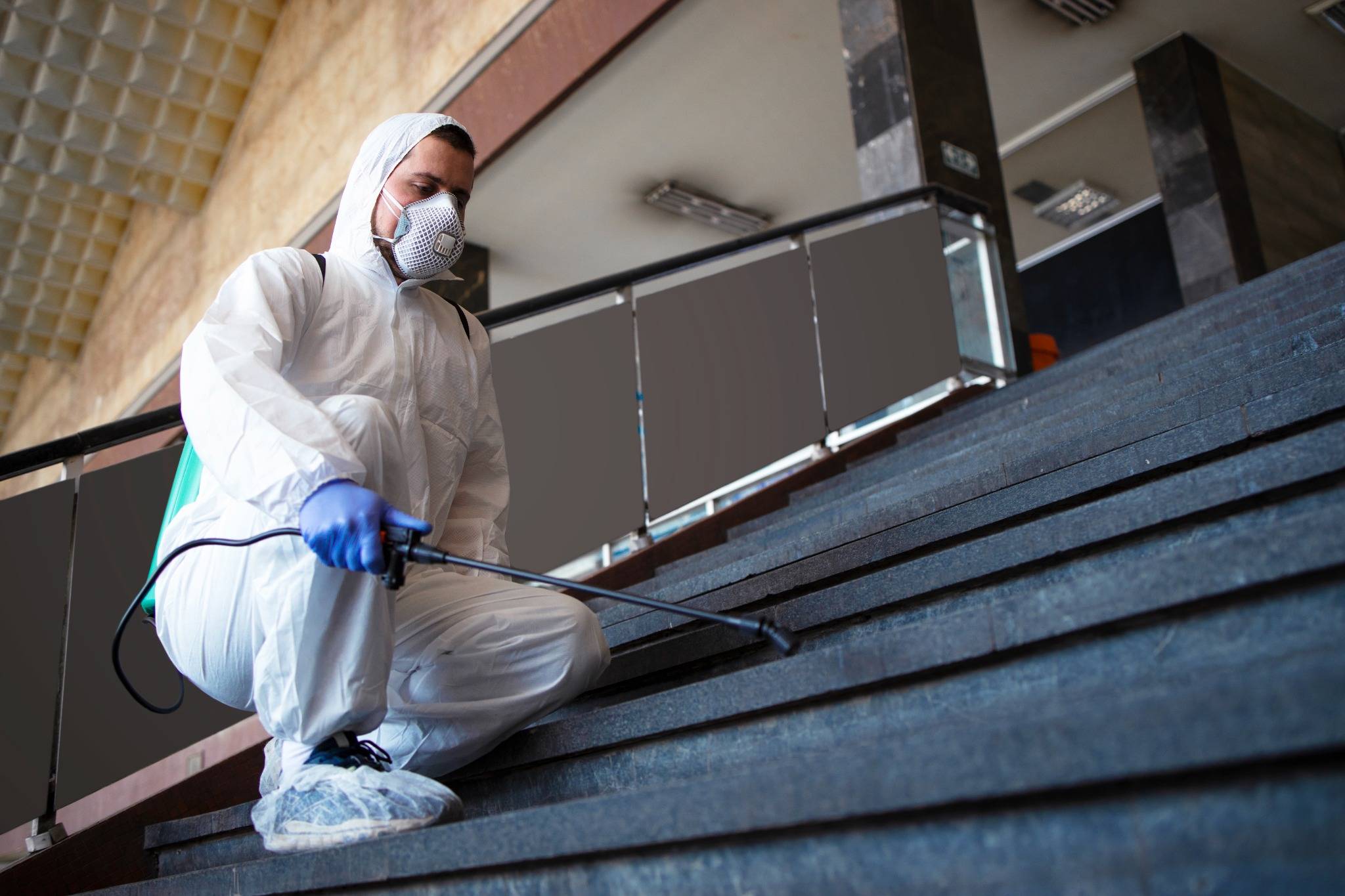 person-white-chemical-protection-suit-disinfecting-public-corridors-steps-stop-spreading-highly-contagious-corona-virus_web